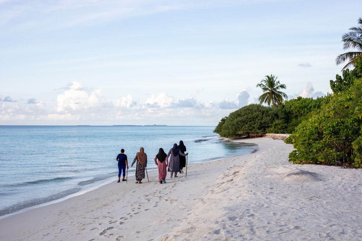 Morning walk on a local Maldivian island beach